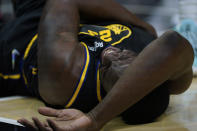 Golden State Warriors forward Draymond Green (23) reacts after falling out of bounds during the first half of an NBA basketball game against the Los Angeles Clippers in Los Angeles, Sunday, Nov. 28, 2021. (AP Photo/Ashley Landis)