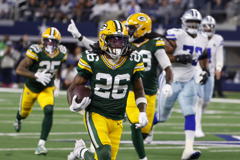 Green Bay Packers safety Darnell Savage (26) runs with the ball after making an interception on a pass by Dallas Cowboys quarterback Dak Prescott during the first half of an NFL football game, Sunday, Jan. 14, 2024, in Arlington, Texas. Savage scored on the interception return. (AP Photo/Michael Ainsworth)