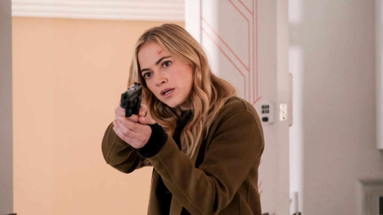  Emily Wickersham holding gun as Ellie Bishop on NCIS 