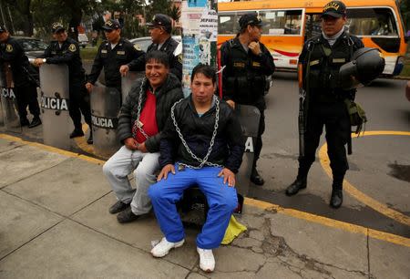 Residents of the town Cerro de Pasco in the Peruvian Andes chained themselves outside of the health ministry to protest for what they describe as rampant pollution from a sprawling polymetallic mine operated by Peruvian mining company Volcan, in Lima, Peru June 22, 2017. REUTERS/Mariana Bazo