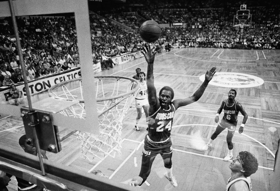 Houston Rockets' Moses Malone goes up for 31 points to lead Houston to a 92-90 victory on May 7, 1981 in Boston. Malone was the high scorer for the  31-points. The photo was taken with a remote control camera mounted behind the background. (AP Photo)