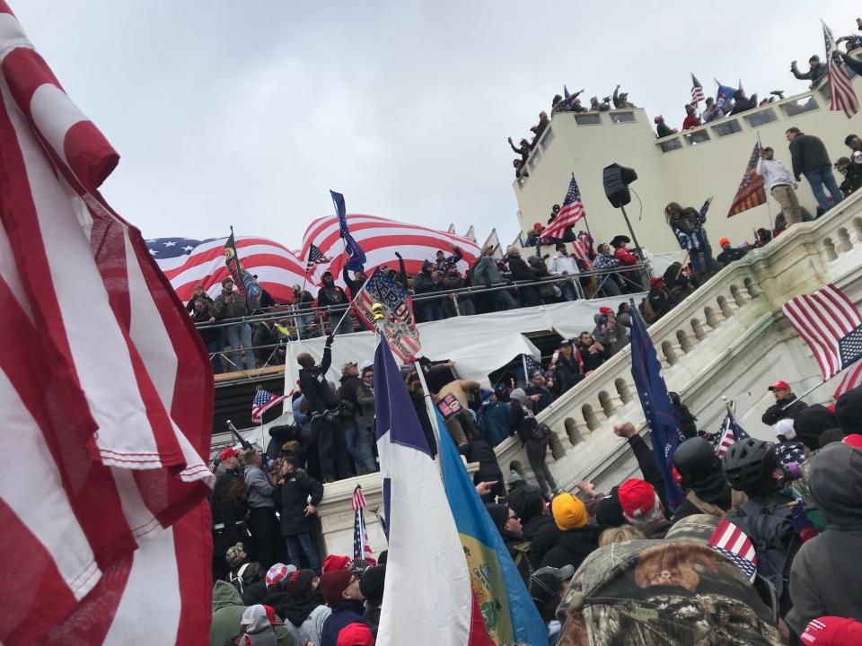 Rioters waved Trump and American flags on the Capitol steps before storming the building.