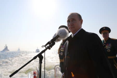 FILE PHOTO: Russia's President Vladimir Putin inspects warships on the Neva river during the Navy Day parade in St Petersburg, Russia, July 29, 2018. Sputnik/Mikhail Klementyev/Kremlin via REUTERS