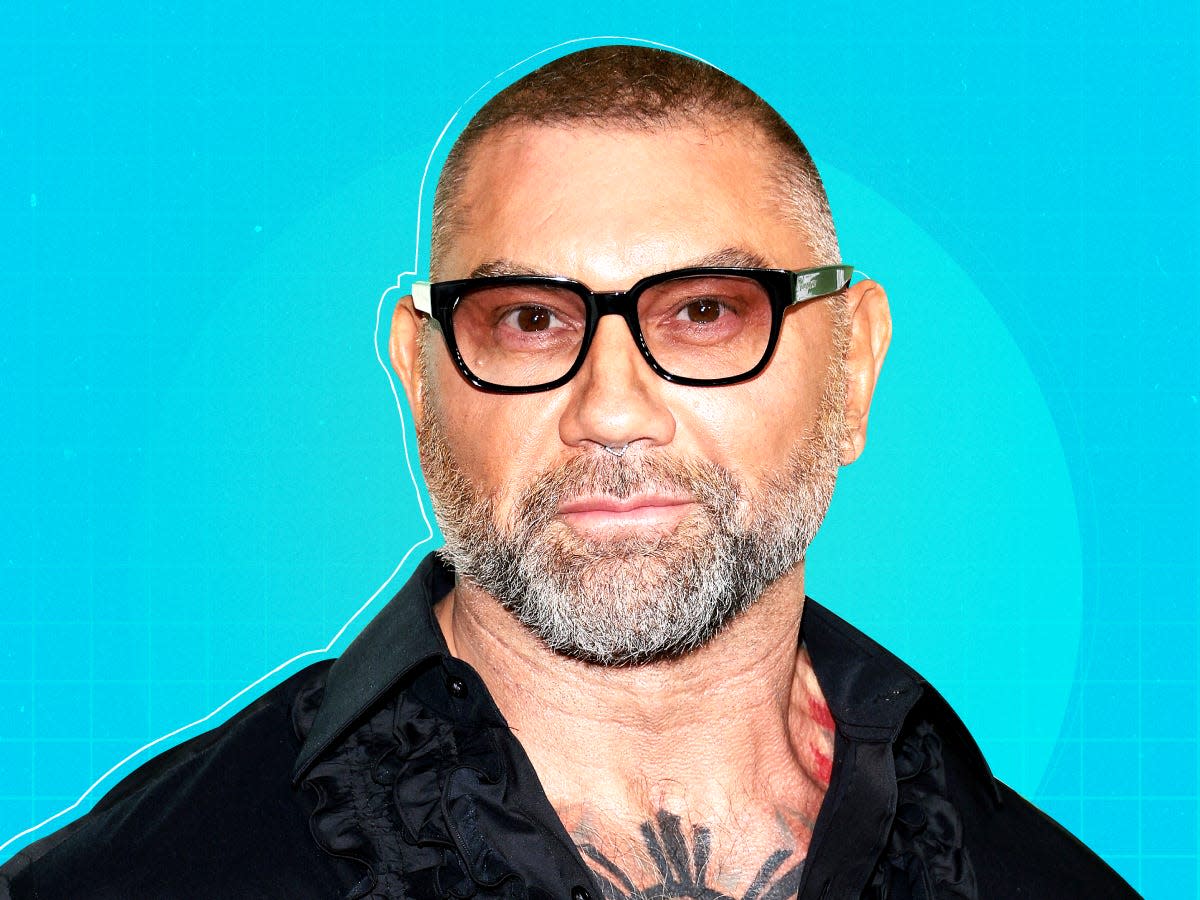 American actor and retired professional wrestler Dave Bautista on blue patterned background