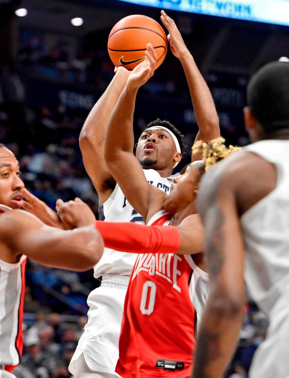 Penn State’s Jalen Pickett shoots for a basket over Ohio State defenders during the game on Sunday, Dec. 5, 2021.