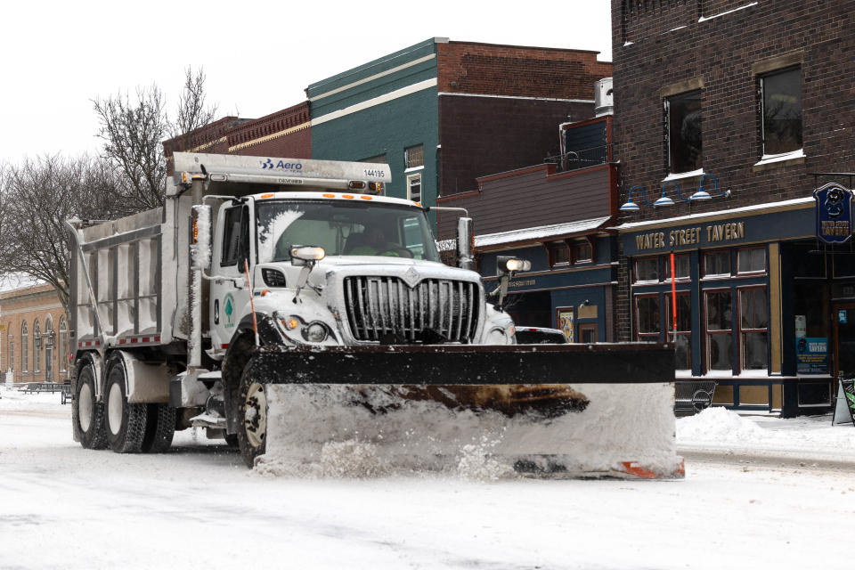 A city of Kent snow plow clears snow from South Water Street in downtown Kent as Winter Storm Elliott hits Ohio Dec. 23.