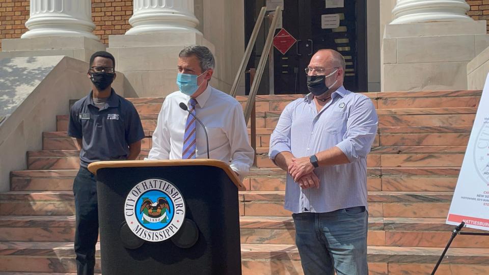 Hattiesburg Mayor Toby Barker announces a job fair for restaurants and the hospitality industry during a news conference on the steps of City Hall, Thursday, May 12, 2021, as Pyro's Pizza General Manager Edward Hargrove, left, and New South Restaurant Group owner Robert St. John listen.