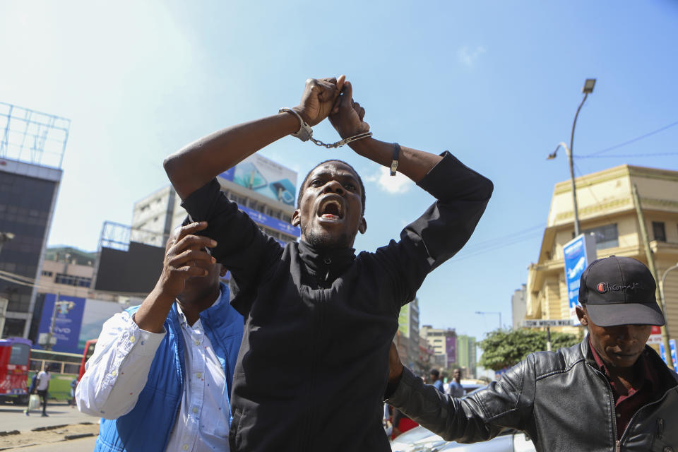 Plain clothes police officers arrest a demonstrator protesting against proposed tax hikes in a finance bill that is due to be tabled in parliament in Nairobi, Kenya, Tuesday, June 18, 2024. Civil society groups say that despite the dozens of arrests, demonstrations and a planned sit-down outside the parliament buildings will continue. (AP Photo/Andrew Kasuku)