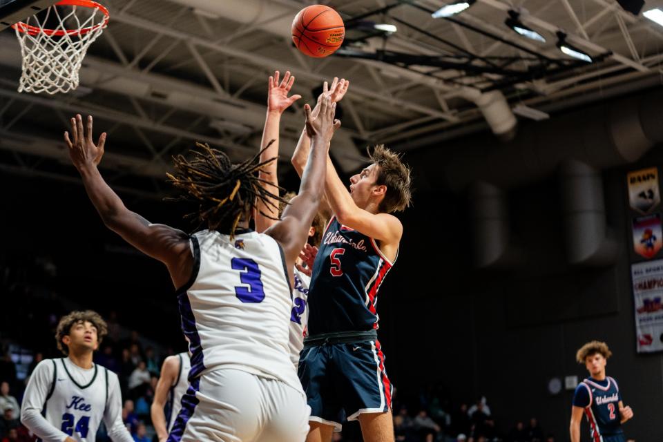 Urbandale's Grant Uecker takes a shot over his Waukee defenders Tuesday, Dec. 12, 2023, at Waukee High School.