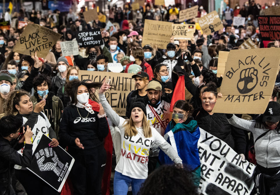 Protesters marching during a Black Lives Matter protest, following the death in Minneapolis police custody of George Floyd, in Sydney, Tuesday, June 2, 2020. (AAP Image/James Gourley) NO ARCHIVING