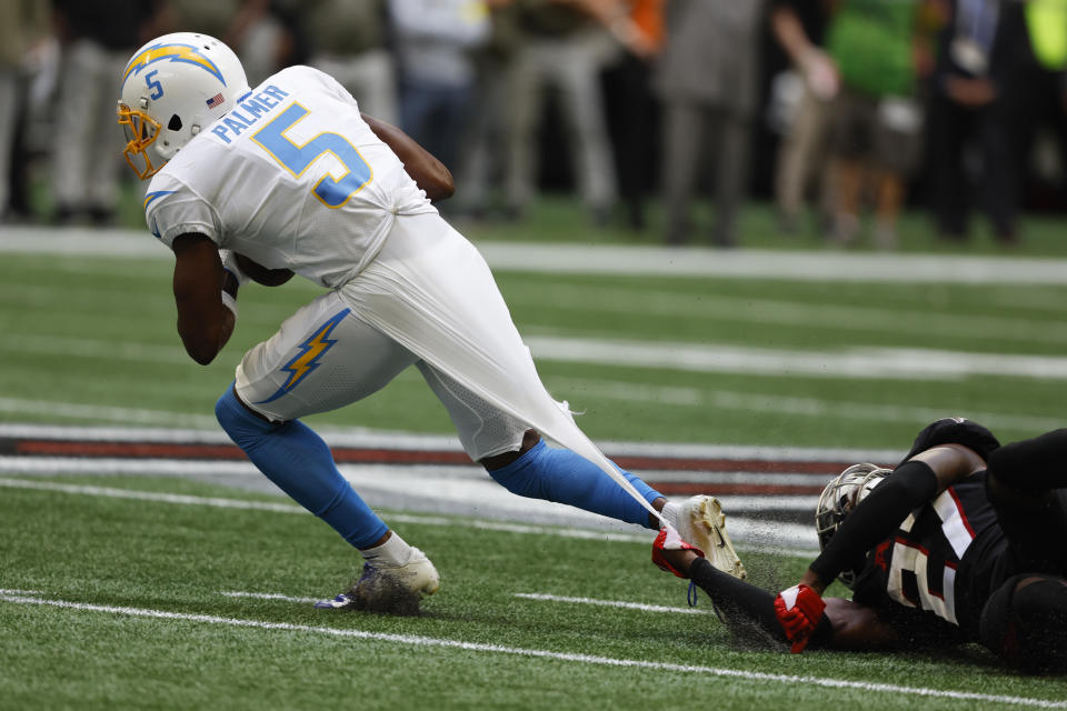 CORRECTS DATE TO SUNDAY, NOV. 6 INSTEAD OF TUESDAY, DEC. 6 - Los Angeles Chargers wide receiver Joshua Palmer (5) runs from Atlanta Falcons safety Richie Grant (27) after catching a pass during the second half of an NFL football game, Sunday, Nov. 6, 2022, in Atlanta. (AP Photo/Butch Dill)