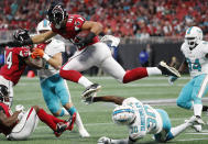 <p>Atlanta Falcons tight end Austin Hooper (81) leaps over Miami Dolphins cornerback Cordrea Tankersley (30) during the first half of an NFL football game, Sunday, Oct. 15, 2017, in Atlanta. (AP Photo/ David Goldman) </p>