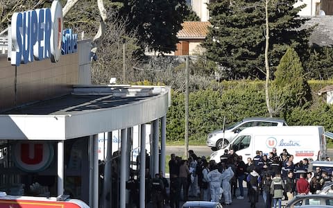 French security and police gather outside the Super U supermarket in the town of Trebes - Credit: PASCAL PAVANI /AFP