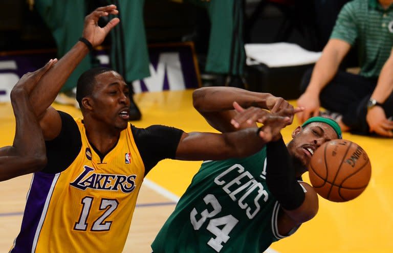 Dwight Howard (L) of the Los Angeles Lakers and Paul Pierce of the Boston Celtics grapple for the ball, on February 20, 2013. Pierce scored 26 points for Boston, whose 113-99 defeat means they have now lost two straight to begin a five-game western road trip