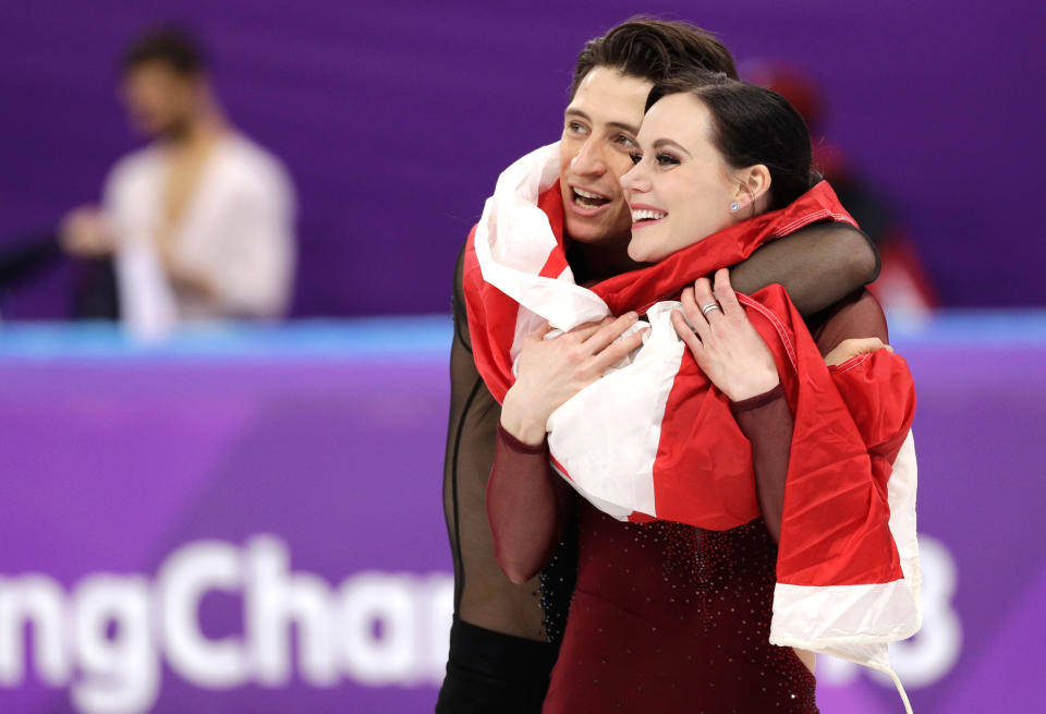 <p>Tessa Virtue and Scott Moir of Canada celebrate during the venue ceremony after winning the gold medal in the ice dance, free dance figure skating final in the Gangneung Ice Arena at the 2018 Winter Olympics in Gangneung, South Korea, Tuesday, Feb. 20, 2018. (AP Photo/David J. Phillip) </p>