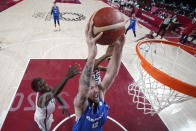 Czech Republic's Ondrej Balvin (12) scores past United States's Jrue Holiday, left, during a men's basketball preliminary round game at the 2020 Summer Olympics, Saturday, July 31, 2021, in Saitama, Japan. (AP Photo/Eric Gay)