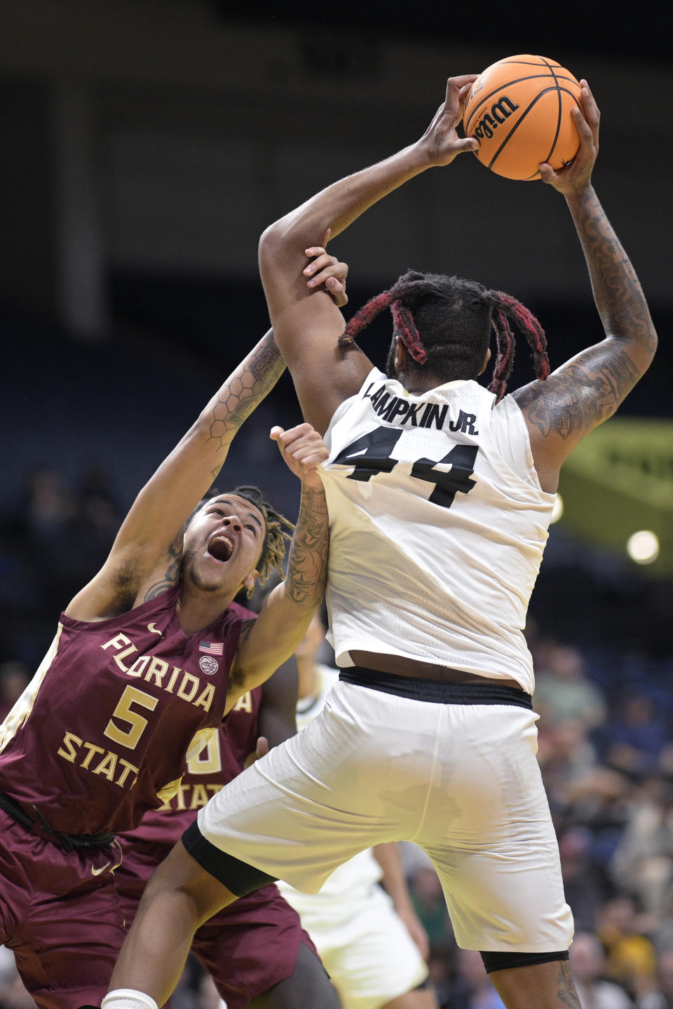 Colorado center Eddie Lampkin Jr. (44) is fouled by Florida State forward De'Ante Green (5) during the first half of an NCAA college basketball game, Tuesday, Nov. 21, 2023, in Daytona Beach, Fla. (AP Photo/Phelan M. Ebenhack)