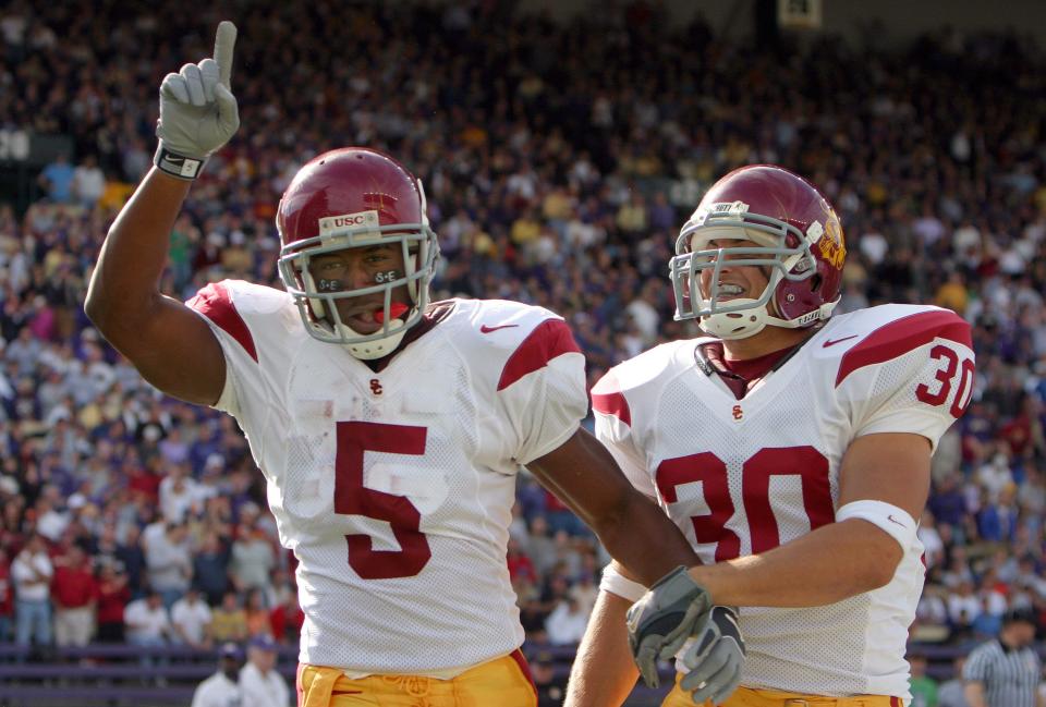 Oct. 22, 2005; Seattle, WA, USA; USC Trojans tailback (5) Reggie Bush celebrates his 1st half touchdown with teammate (30) Mike Brittingham during play against the Washington Huskies at Husky Stadium. Credit: Photo By Scott Cohen-USA TODAY Sports Copyright (c) 2005 Scott Cohen