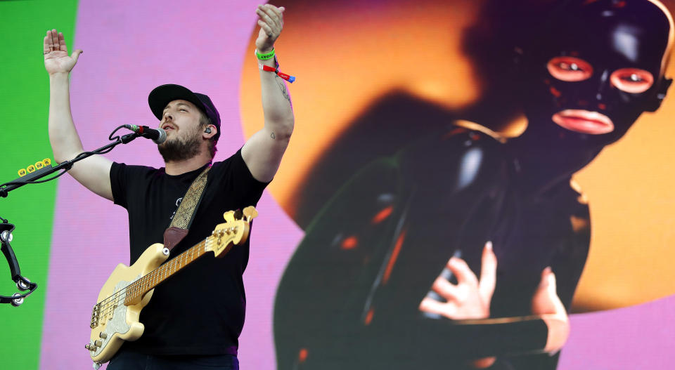 FILE - In this May 25, 2018 file photo, Portugal. The Man bassist Zachary Scott Carothers performs at the Boston Calling Music Festival in Allston, Mass. The state of Alaska's new hold music is on hold. A project to replace the sleepy hold music for state office lines with music by Alaska artists drew widespread attention when it was announced in November, touting Portugal. The Man and four other artists with Alaska ties. A spokesman for Gov. Mike Dunleavy says it was muted shortly thereafter after concerns with some of the music were raised by the public. (Photo by Winslow Townson/Invision/AP, File)
