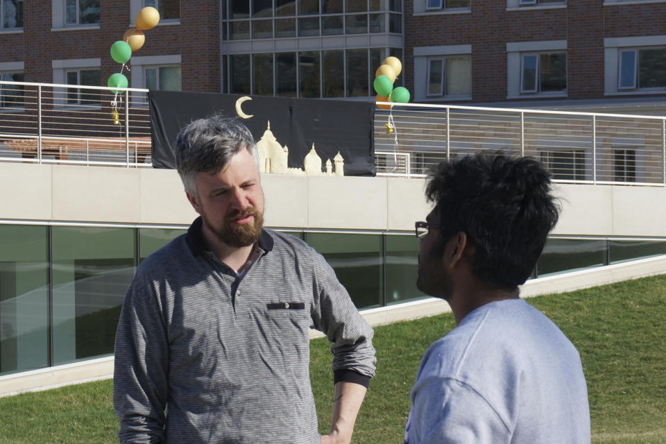 Neil Ellingson, left, the Protestant chaplain at the University of St. Thomas, talks with a student attending the school's celebration for the end of the Muslim holy month of Ramadan in St. Paul, Minn., on Saturday, May 7, 2022. Campus ministry helped organize the event, which drew Muslim and non-Muslim students with a variety of stress-reducing activities, as many faith leaders across US campuses seek ways to help students manage growing mental health distress. (AP Photo/Giovanna Dell'Orto)