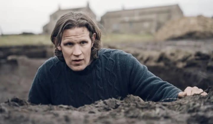 A man looks up from a hole in the ground in Starve Acre.