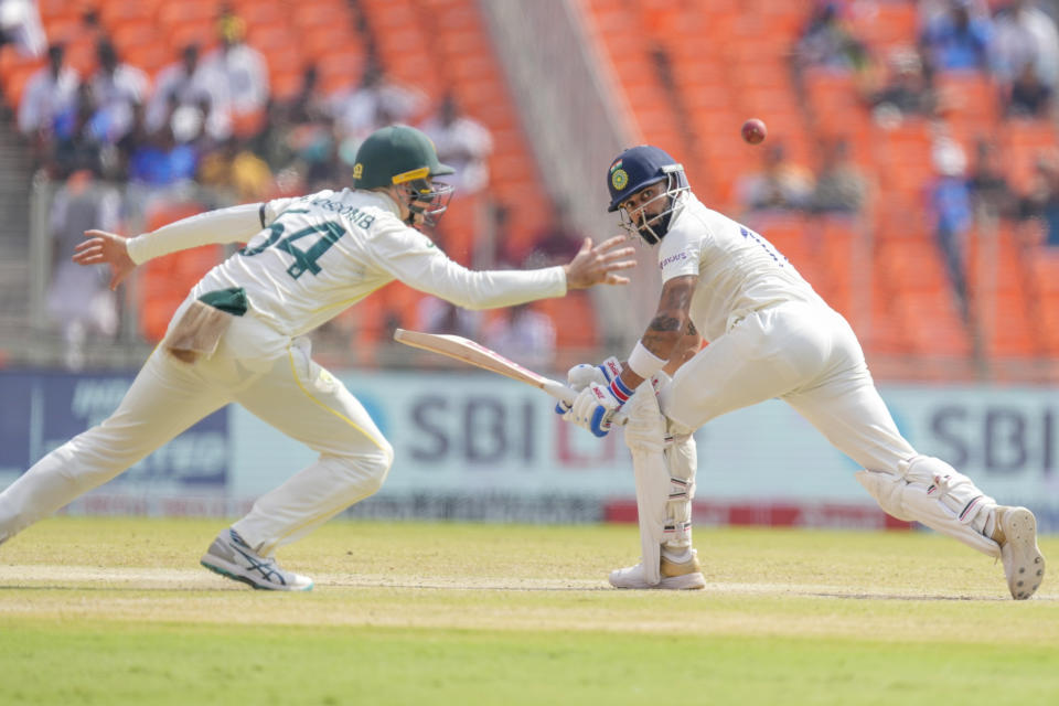 India's Virat Kohli, right, plays a shot during the fourth day of the fourth cricket test match between India and Australia in Ahmedabad, India, Sunday, March 12, 2023. (AP Photo/Ajit Solanki)