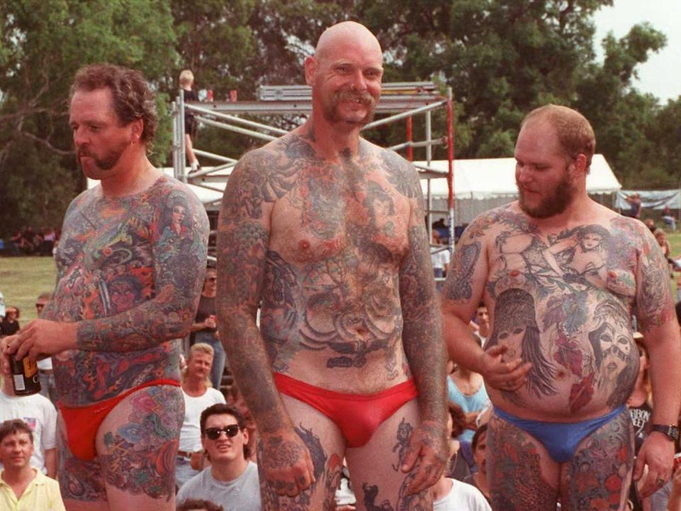 Contestants compare body art at a tattoo show in Australia.