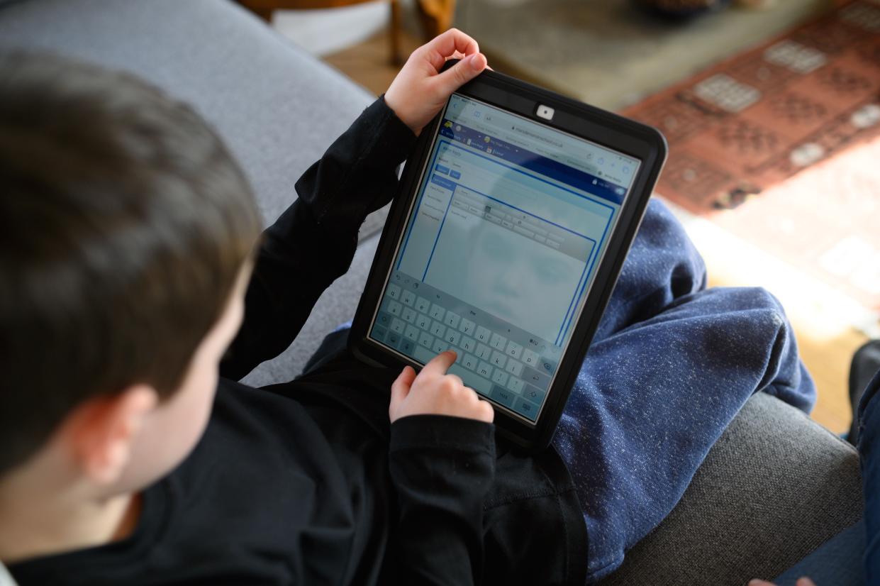 A child uses a tablet  (AFP via Getty Images)