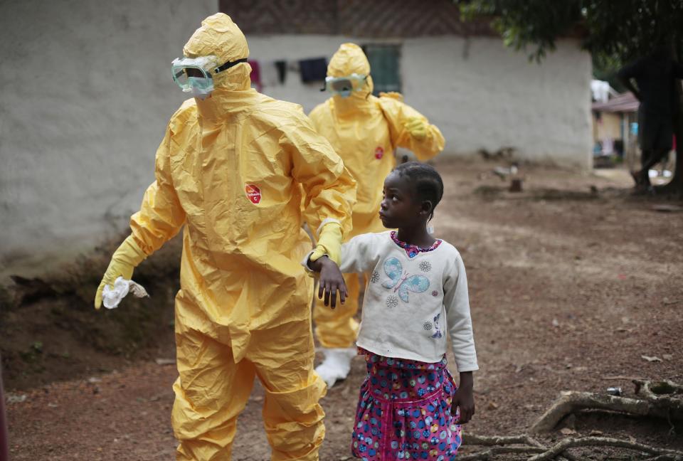 FILE - Nowa Paye, 9, is taken to an ambulance after showing signs of the Ebola infection in the village of Freeman Reserve, about 30 miles north of Monrovia, Liberia, on Sept. 30, 2014. Liberians gathered Wednesday, March 13, 2024 to commemorate a decade since the country was first hit by a devastating outbreak of Ebola that killed thousands in West Africa, adding to the region's economic and political troubles. (AP Photo/Jerome Delay, File)