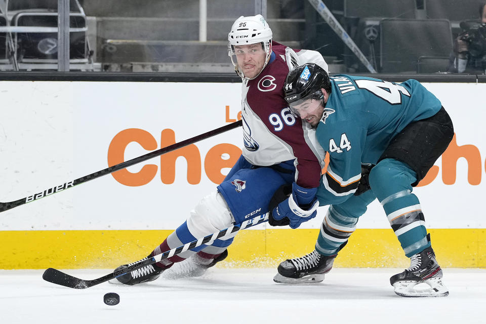 Colorado Avalanche right wing Mikko Rantanen (96) battles for the puck against San Jose Sharks defenseman Marc-Edouard Vlasic (44) during the second period of an NHL hockey game in San Jose, Calif., on Wednesday, May 5, 2021. (AP Photo/Tony Avelar)