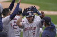 Houston Astros' Chas McCormick (6) is congratulated by teammates after hitting a three-run home run against the Oakland Athletics during the sixth inning of a baseball game in Oakland, Calif., Sunday, April 4, 2021. (AP Photo/Jeff Chiu)