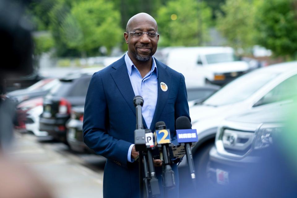 Sen. Raphael Warnock speaks to journalists after voting Friday, May 6, 2022 in Atlanta, Georgia, during early primary voting.