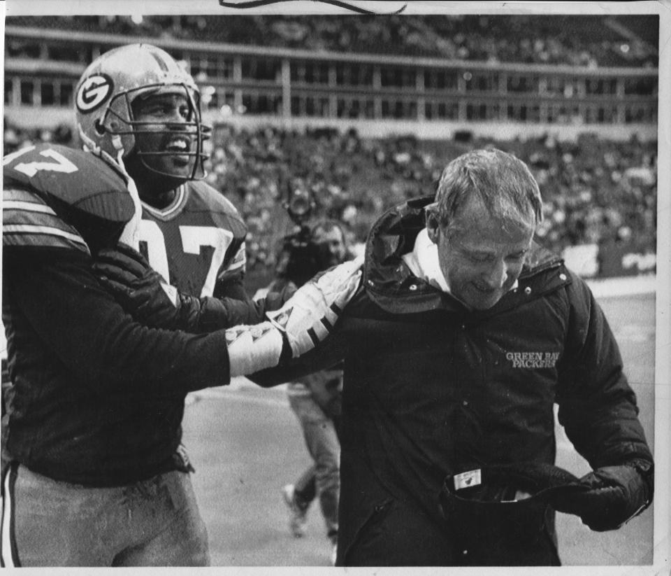 Green Bay linebacker Tim Harris congratulates coach Lindy Infante after the Packers beat the Dallas Cowboys.
