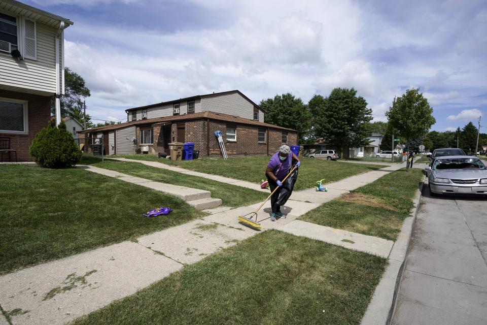 Church volunteer Patricia Antoine-Norton helps clean up the neighborhood where Jacob Blake was shot last Sunday on Saturday, Aug. 29, 2020, in Kenosha, Wis. Family members of Jacob Blake, a Black man who was paralyzed after a Kenosha police officer shot him in the back, are leading a march and rally Saturday to call for an end to police violence. (AP Photo/Morry Gash)