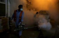 Pakistani health workers fumigate to kill mosquitos in an effort to prevent an outbreak of dengue fever, in Peshawar, Pakistan. Friday, Sept. 23, 2022. Pakistan has deployed thousands of additional doctors and paramedics in the country's worst flood-hit province to contain the spread of diseases that have killed over 300 people among the flood victims, officials said Friday. (AP Photo/Muhammad Sajjad)