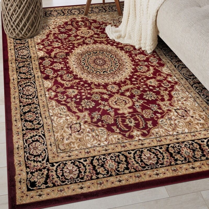 Ornate rug with intricate patterns under a cozy beige blanket on a couch, perfect for adding elegance to your living room decor