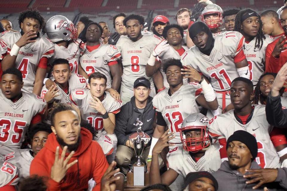 The South Pointe High School varsity football team poses after winning a fourth straight 4A state championship on Saturday.