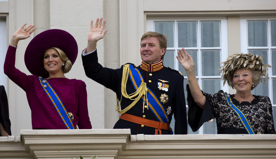 Dutch Queen Beatrix, right, Crown Prince Willem Alexander, centre, and his wife Princess Maxima, left, wave to wellwishers from the balcony of Royal Palace Noordeinde after the Queen officially opened the new parliamentary year with a speech outlining the government's plans for its 2013 budget in The Hague, Netherlands, Tuesday, Sept. 18, 2012. Queen Beatrix will address the nation amid the usual pomp, but the in uncomfortable knowledge that her speech was written by a Cabinet that is about to be replaced after national elections last week. (AP Photo/Vincent Jannink)