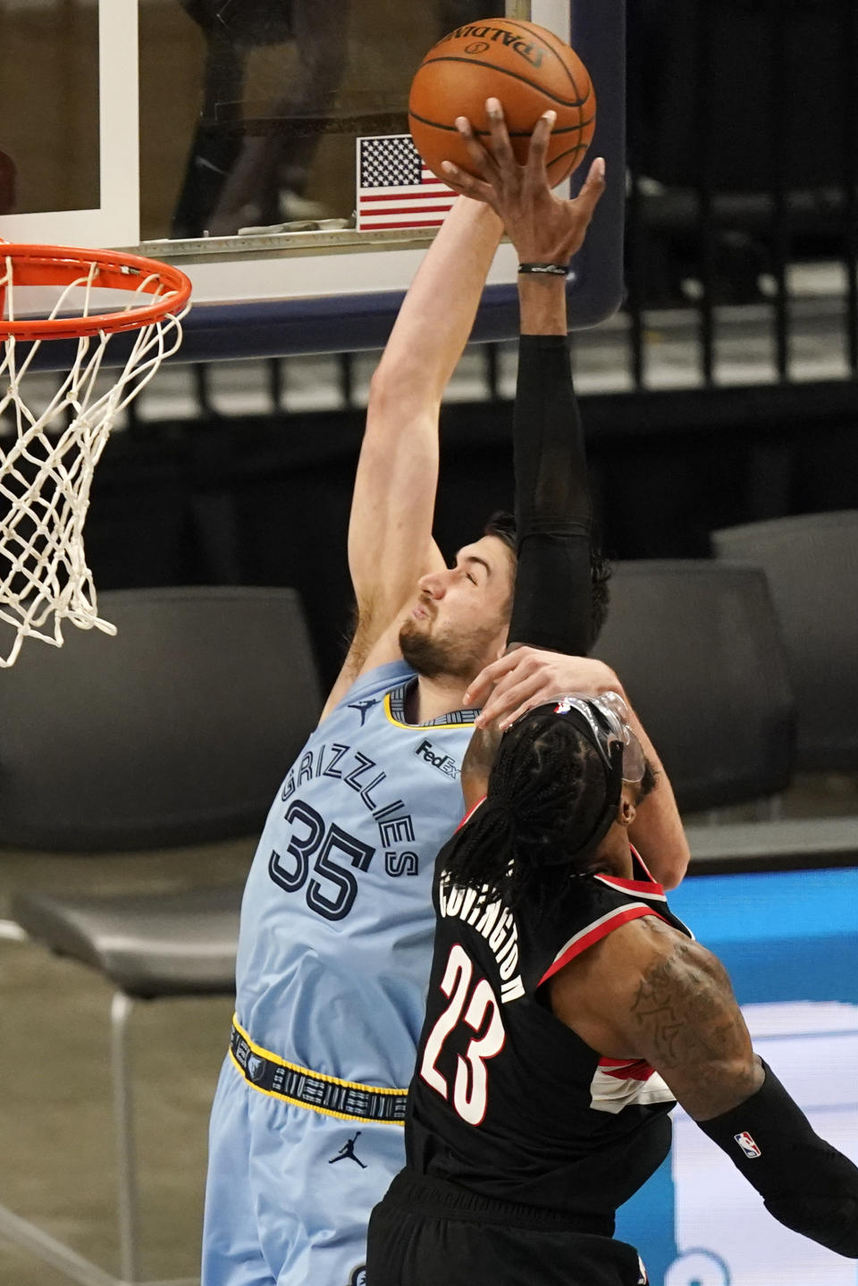 Memphis Grizzlies' Killian Tillie (35) is fouled by Portland Trail Blazers' Robert Covington (23) in the second half of an NBA basketball game Wednesday, April 28, 2021, in Memphis, Tenn. (AP Photo/Mark Humphrey)