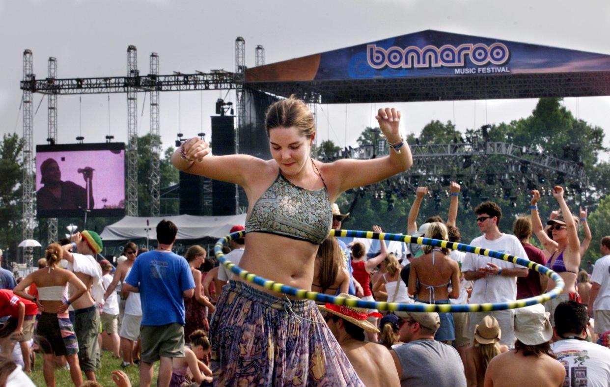 Maleana Kepler from Milton, Pennsylvania, hula hoops to the music of the Dirty Dozen Brass Band during the first Bonnaroo Music Festival in 2002.