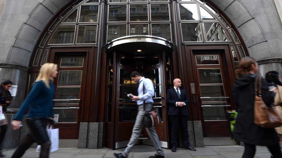 staff walk past Goldman Sachs offices