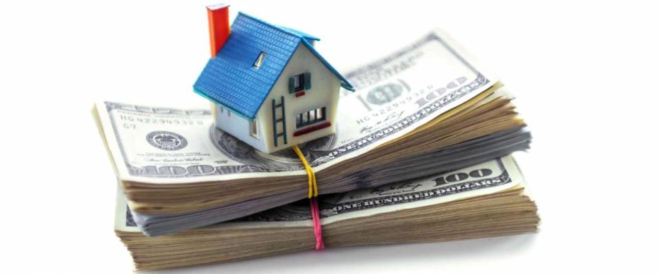 house model on dollar cash stack isolated