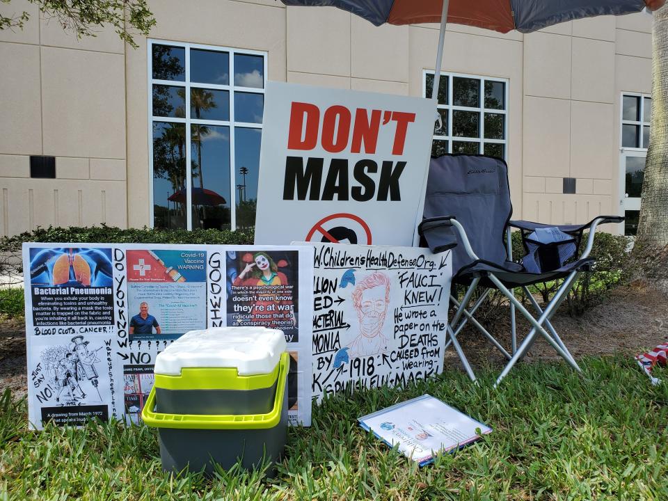 A "No Mask" advocate's chair sits empty in front of the Collier County Public Schools administrative center Tuesday. The school board voted to end school face mask requirements.