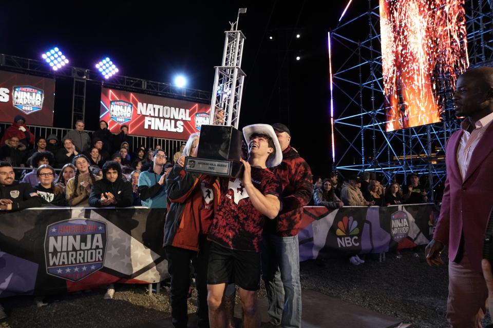 Vance Walker hoists his trophy in the air after winning.