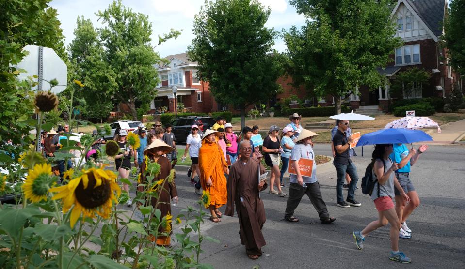 A group heads west through Mesta Park on Sunday, Aug. 7, 2022, during the Peace Walk through OKC's Asian District.