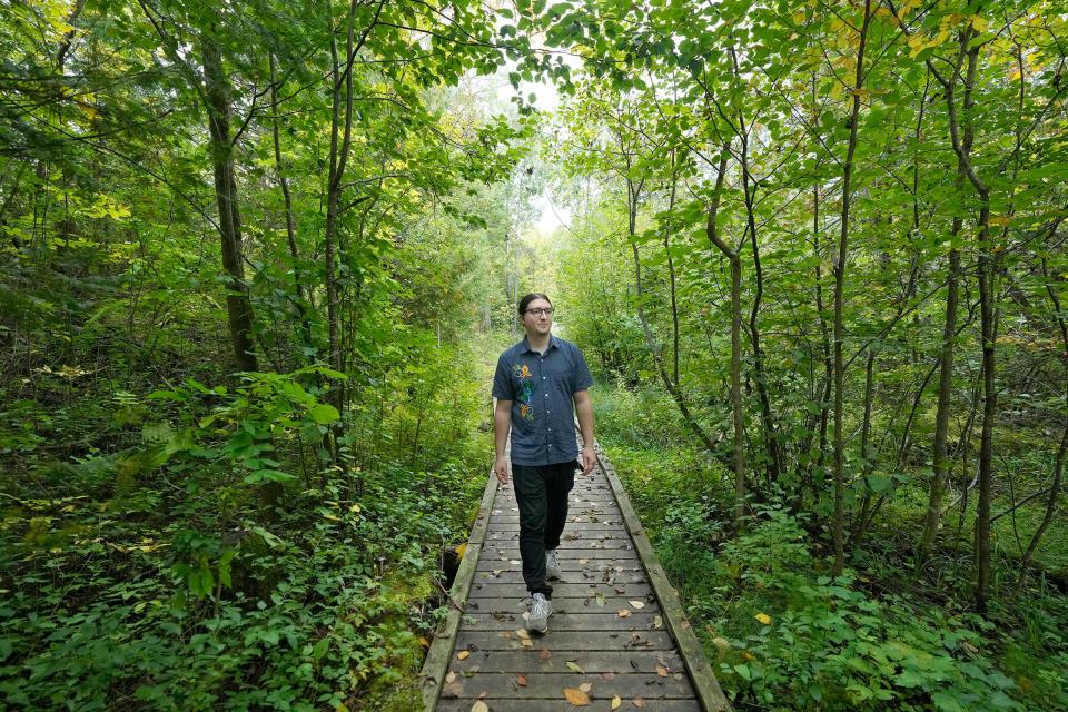 Bazile Minogiizhigaabo Panek, a member of the Red Cliff Band of Lake Superior Ojibwe and consultant for the Institute for Tribal Environmental Professionals based in Arizona, walks along a trail at Prentice Park, just south of Lake Superior in Ashland in September 2023. Panek has seen positive shifts in recent years with more agencies, researchers and organizations asking to consult with tribes and integrate traditional ecological knowledge.
