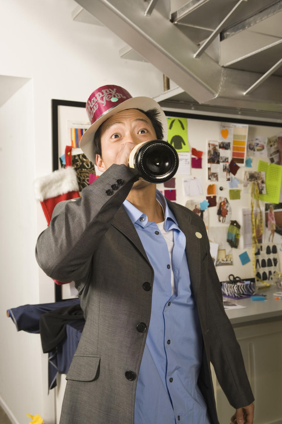 person drinking from the bottle in an office