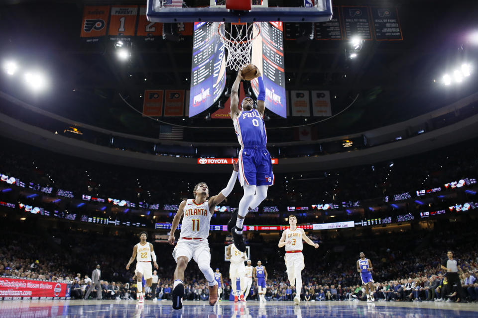 Philadelphia 76ers' Josh Richardson (0) goes up for a dunk past Atlanta Hawks' Trae Young (11) during the first half of an NBA basketball game, Monday, Feb. 24, 2020, in Philadelphia. (AP Photo/Matt Slocum)