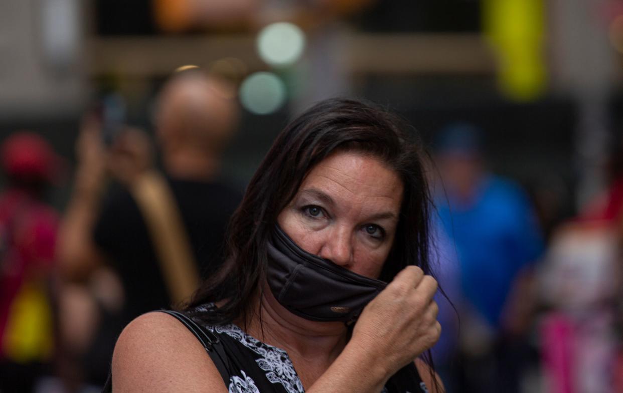 A woman wears a face mask in Midtown Manhattan in New York on July 29 2021. - Every US federal worker must either declare they are fully vaccinated against Covid-19 or wear masks and be regularly tested, President Joe Biden was to announce July 29, 2021, the White House said, as his administration beefs up actions against the surging delta variant. The governors of New York and New Jersey on July 28, 2021 publicly backed the idea of indoor masking for vaccinated people in high Covid-19 risk areas. (Photo by Kena Betancur / AFP) (Photo by KENA BETANCUR/AFP via Getty Images)