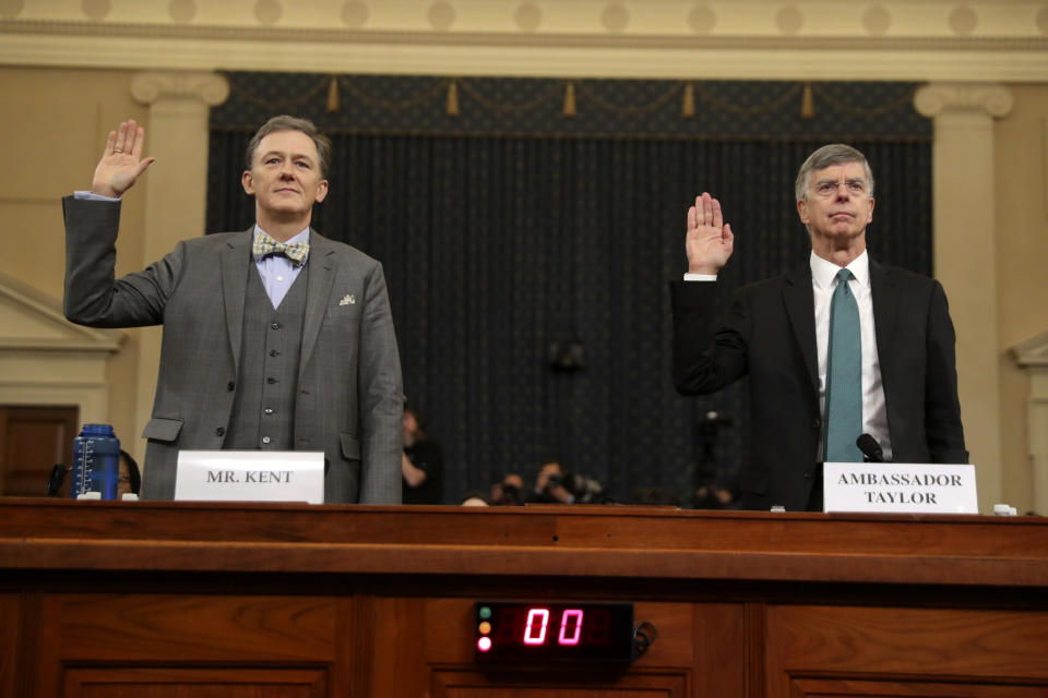 Career Foreign Service officer George Kent and top U.S. diplomat in Ukraine William Taylor, right, are sworn in to testify during the first public impeachment hearing of the House Intelligence Committee on Capitol Hill, Wednesday Nov. 13, 2019 in Washington.(AP Photo/Andrew Harnik)
